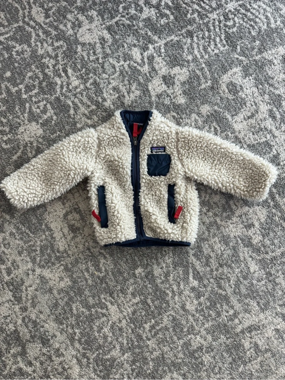 Patagonia Cream Sherpa Jacket with Navy Accents and Red Pulls